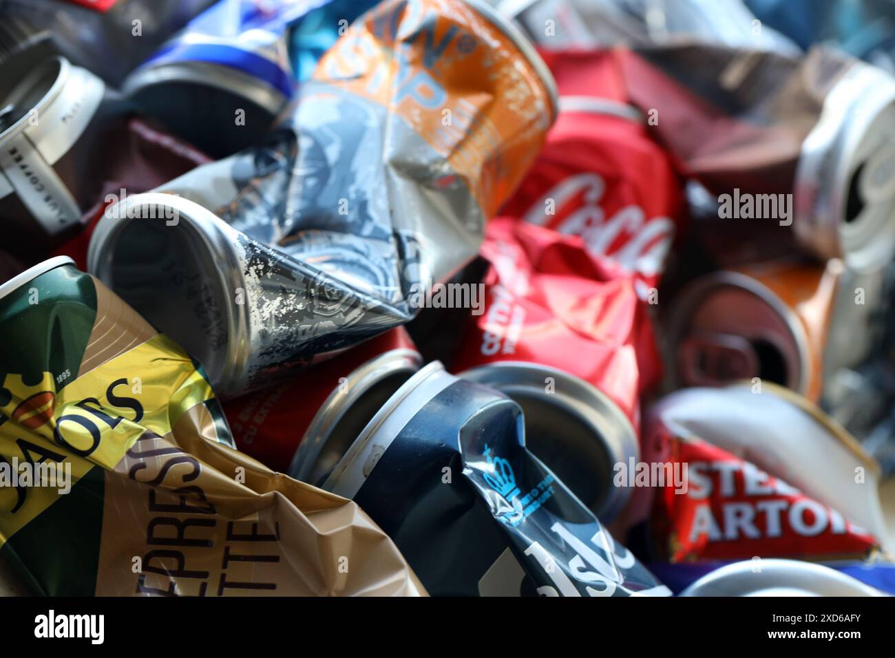 KYIV, UKRAINE - APRIL 20, 2024 Background of various crashed beer cans. Recycle aluminum metal crushed tin can waste close up Stock Photo