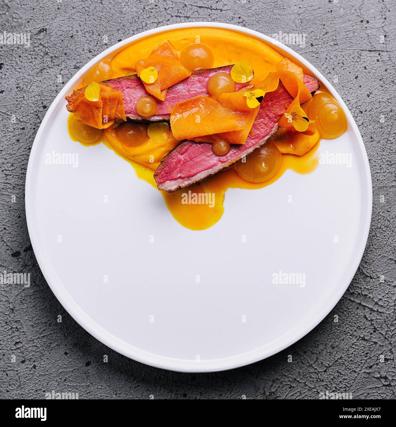 Exquisite serving juicy duck tenderloin with carrot puree Stock Photo