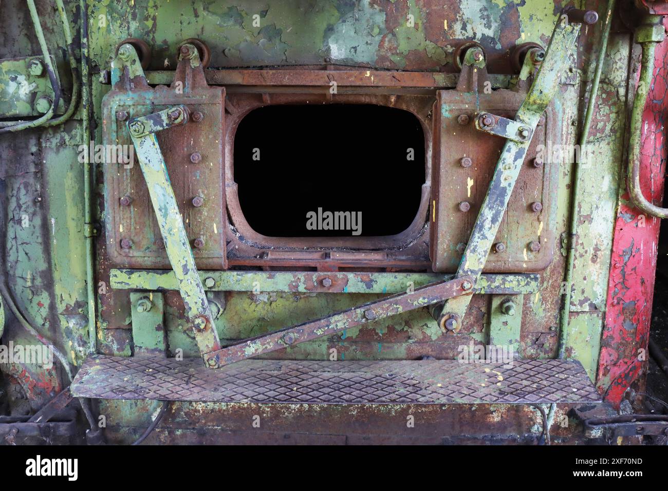 A close-up fragment of the open firebox in the engine of an abandoned retro locomotive. Stock Photo