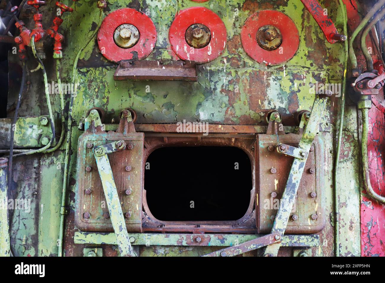 Fragment of the interior of the cabin, engine, firebox of an abandoned, non-working locomotive. Open oven. Stock Photo