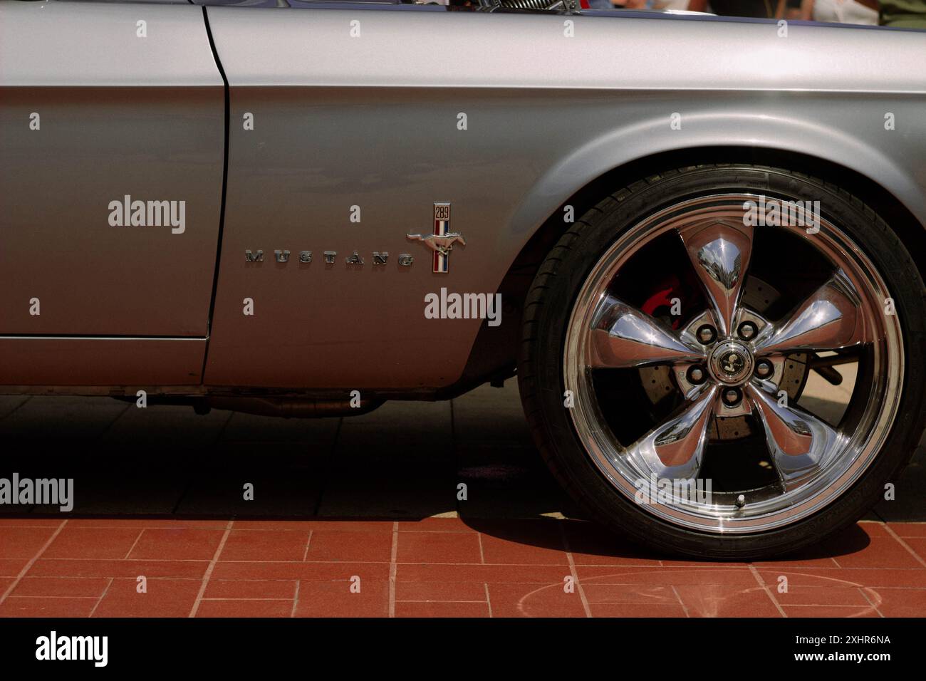 Side view of 1966 Ford Mustang car, showing logo and one wheel Stock Photo