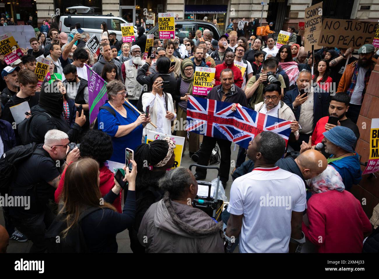 Manchester, UK. 25th July, 2024. People gather outside Andy Burnhams office to protest against the GMP. A man was violently assaulted by a police officer while being arrested at Manchester airport. The incident took place on Tuesday when police intervened in an altercation between members of the public in terminal 2 of the airport. Credit: Andy Barton/Alamy Live News Stock Photo