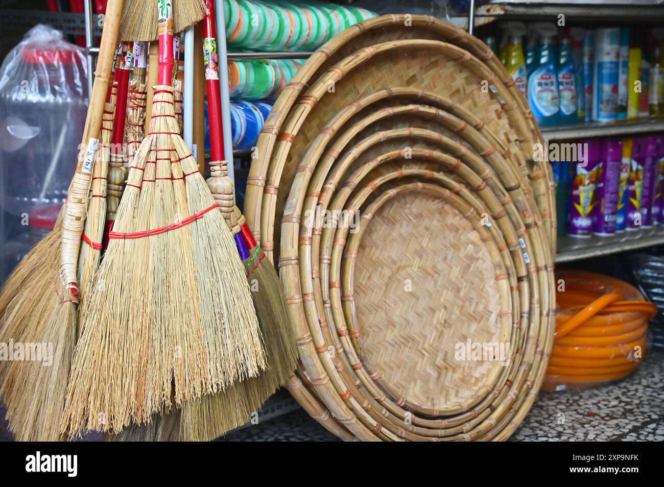 Showcase bamboo brooms and baskets at a traditional market hardware store, highlighting practical and eco-friendly craftsmanship. Stock Photo