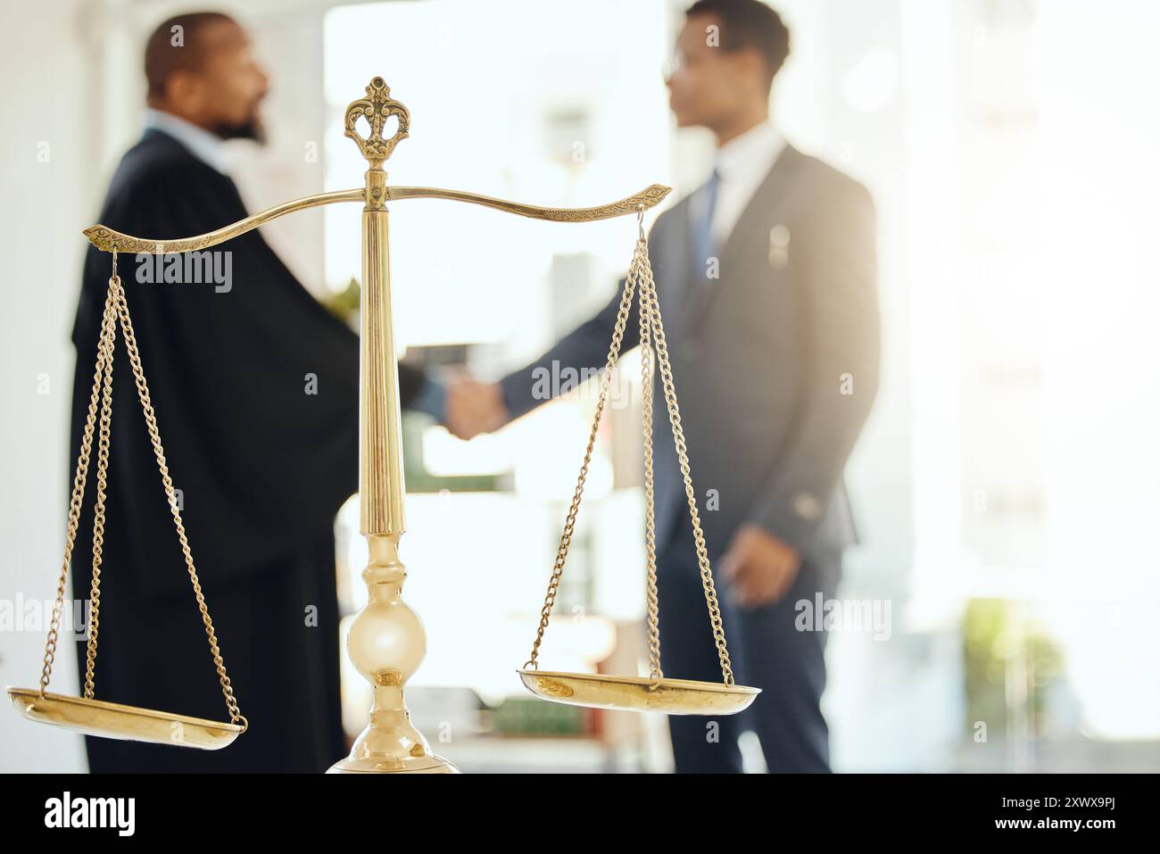 Handshake, legal and scale with judge meeting lawyer in chambers for agreement, deal or welcome. Balance, law and thank you with attorney people Stock Photo