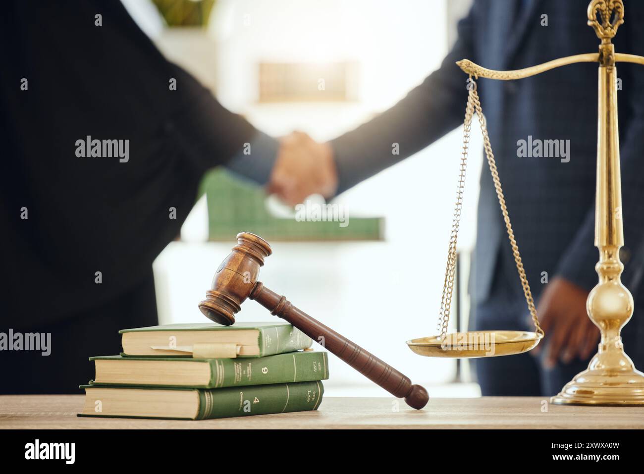 Gavel, handshake and scale with judge meeting lawyer in chambers for agreement, deal or welcome. Books, law and thank you with attorney people shaking Stock Photo