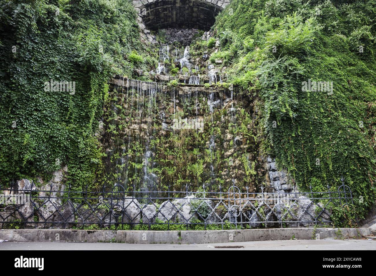 Hungary, Budapest, man-made waterfall on Gellert Hill, water cascade surrounded by lush creeping plants, Europe Stock Photo