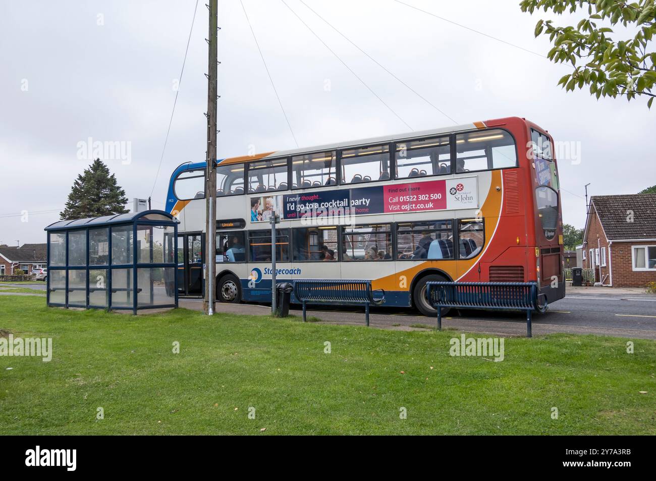 Double deck bus at bus stop, The Parade, Cherry Willingham, Lincoln, Lincolnshire, England, UK Stock Photo