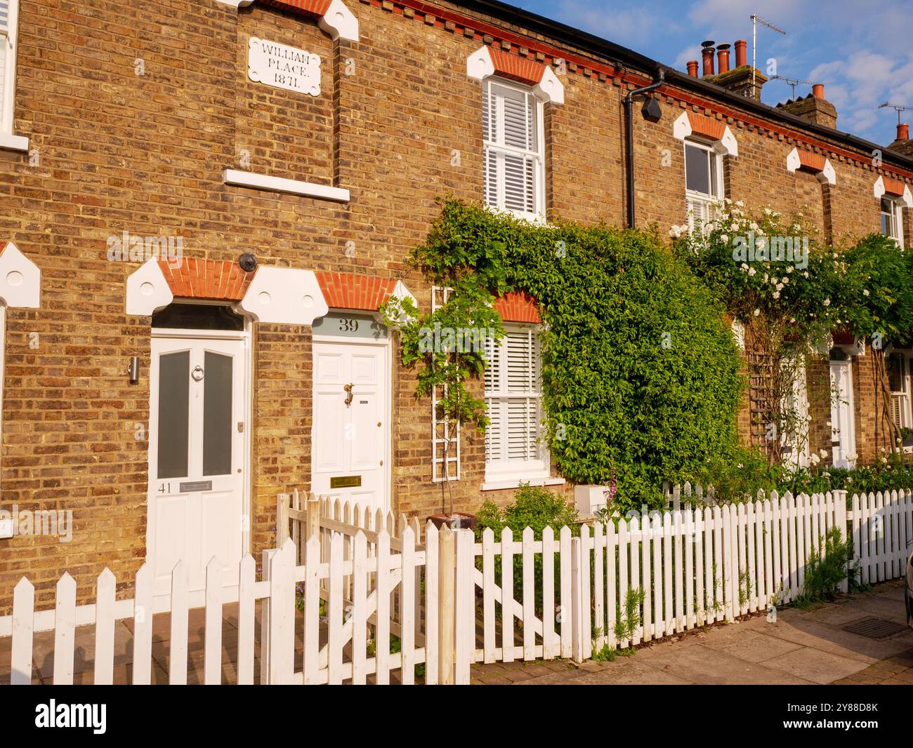 Row of Victorian terraced houses with white wooden picket fence in Gentleman's Row, Enfield, London, UK Stock Photo