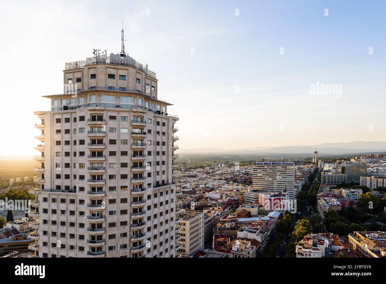 Madrid, Spain, August 24, 2020: Madrid city centre aerial panoramic view at sunset. Madrid Tower skyscraper on foreground. Sun flare, Europe Stock Photo