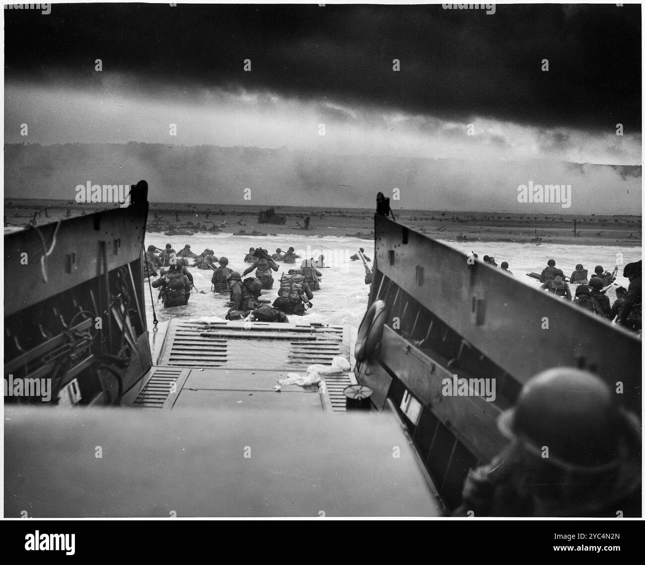 Archive image of D-Day landings 6 June 1944. American troops of the 1st Infantry Division leave a landing craft from the USS Samuel Chase onto Omaha Beach, Normandy.  The photographer, Robert F Sargent, titled the image Into the Jaws of Death. Stock Photo