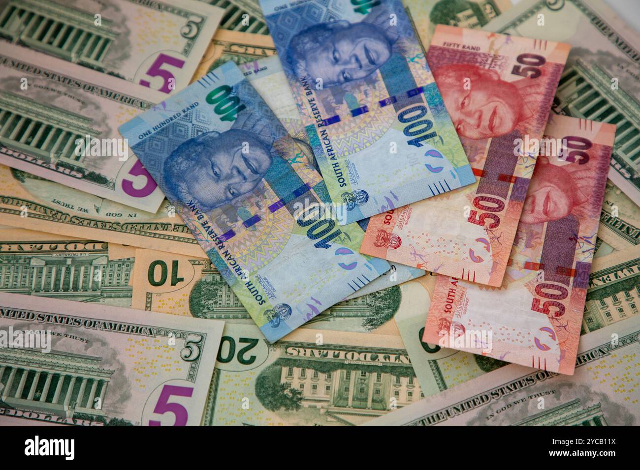 Selective focus on different denominations of US Dollar notes and South African Rand notes.  Concept for exchange rate. Stock Photo