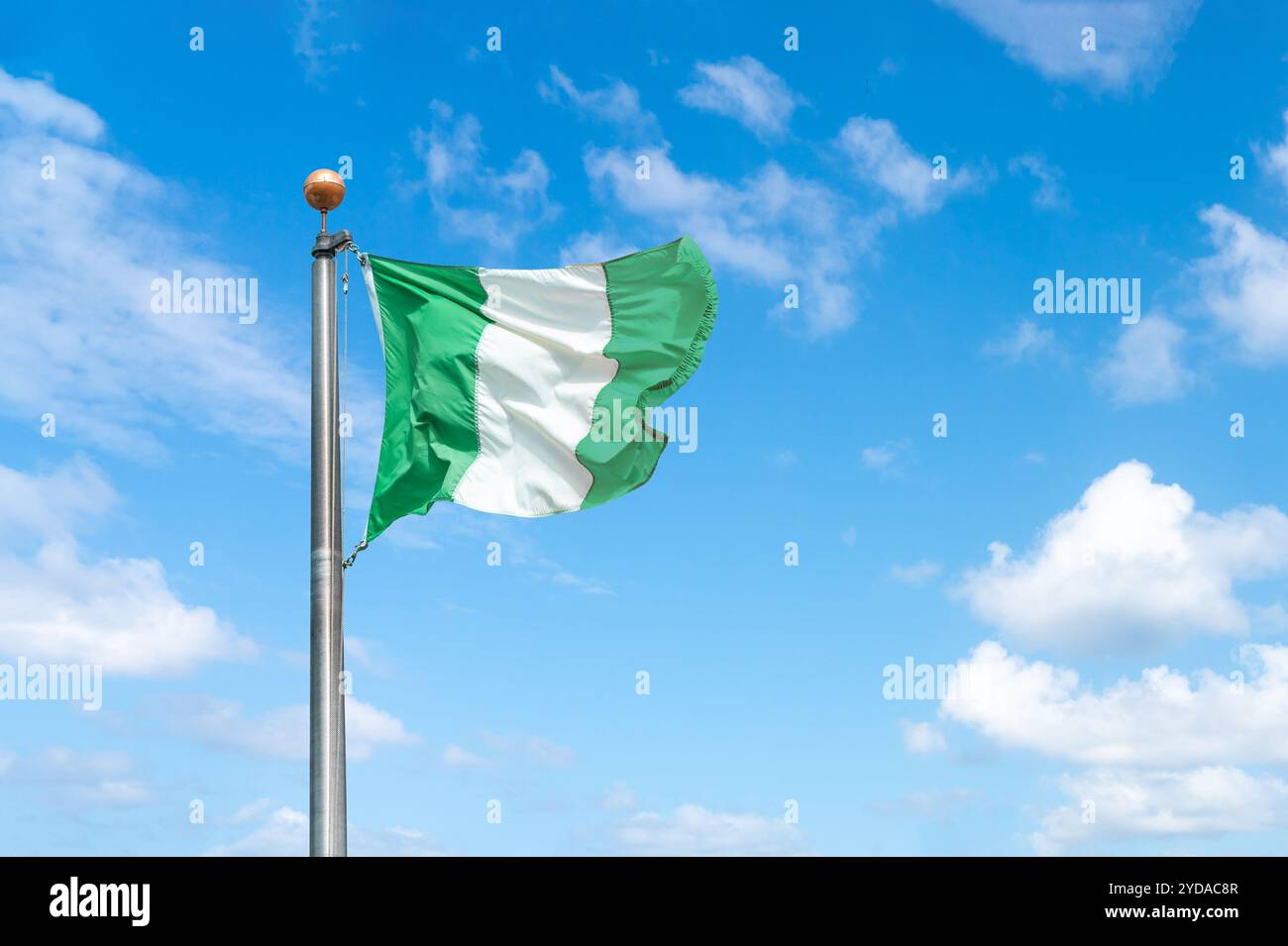 Flag of Nigeria on a background blue sky Stock Photo