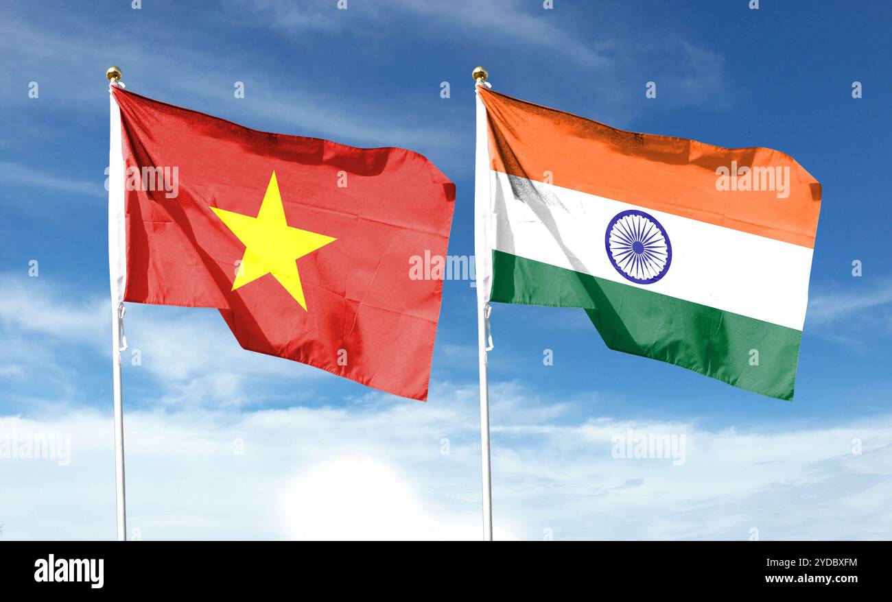 Vietnamese flag and Indian flag on cloudy sky. flying in the sky Stock Photo