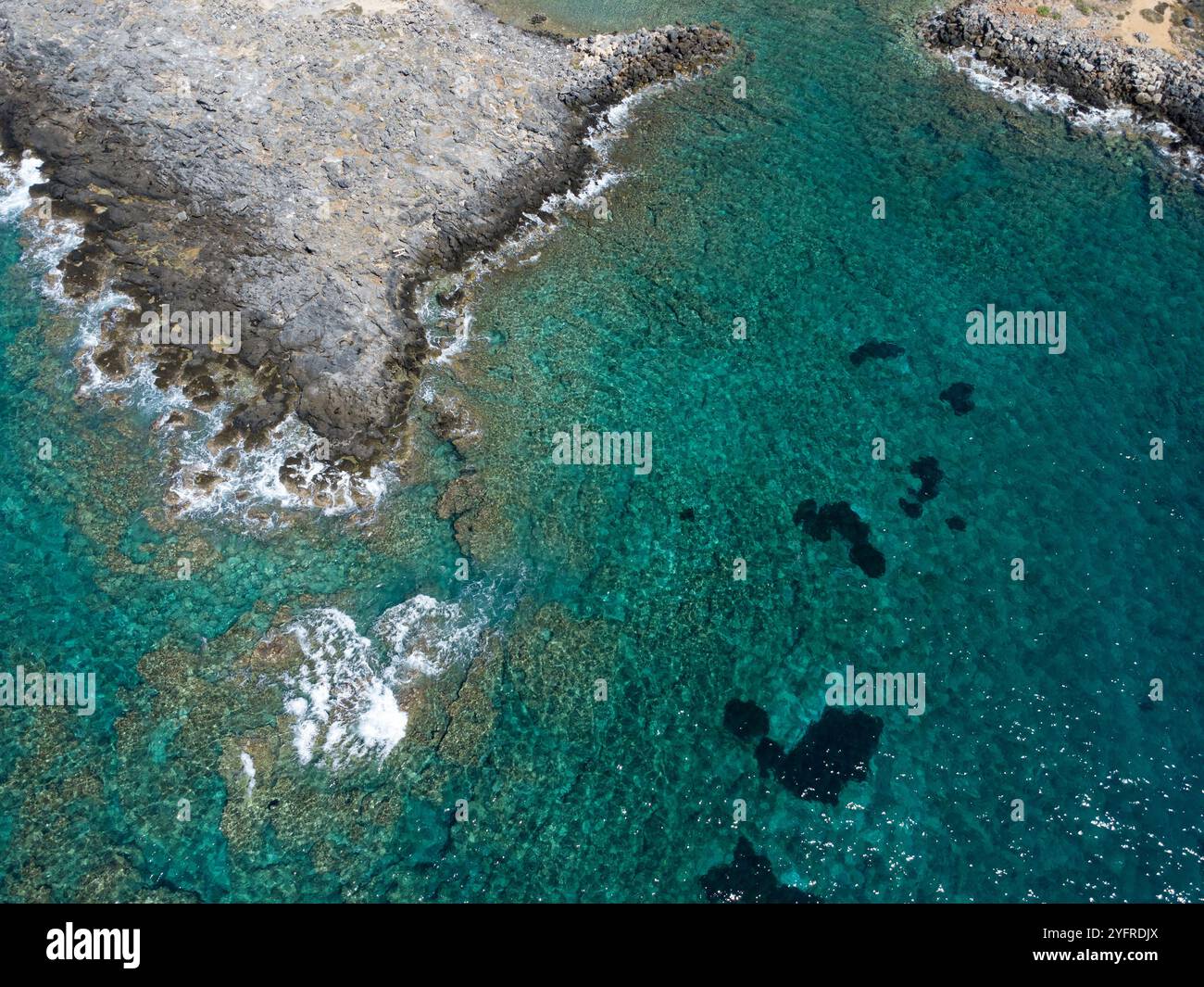 Crystal water of the sea in Paleochora rocks and pebble beach - Greece Stock Photo