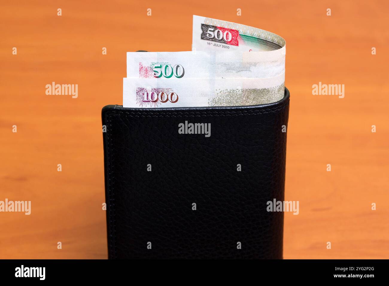 Kenyan money - shilling in the black wallet Stock Photo