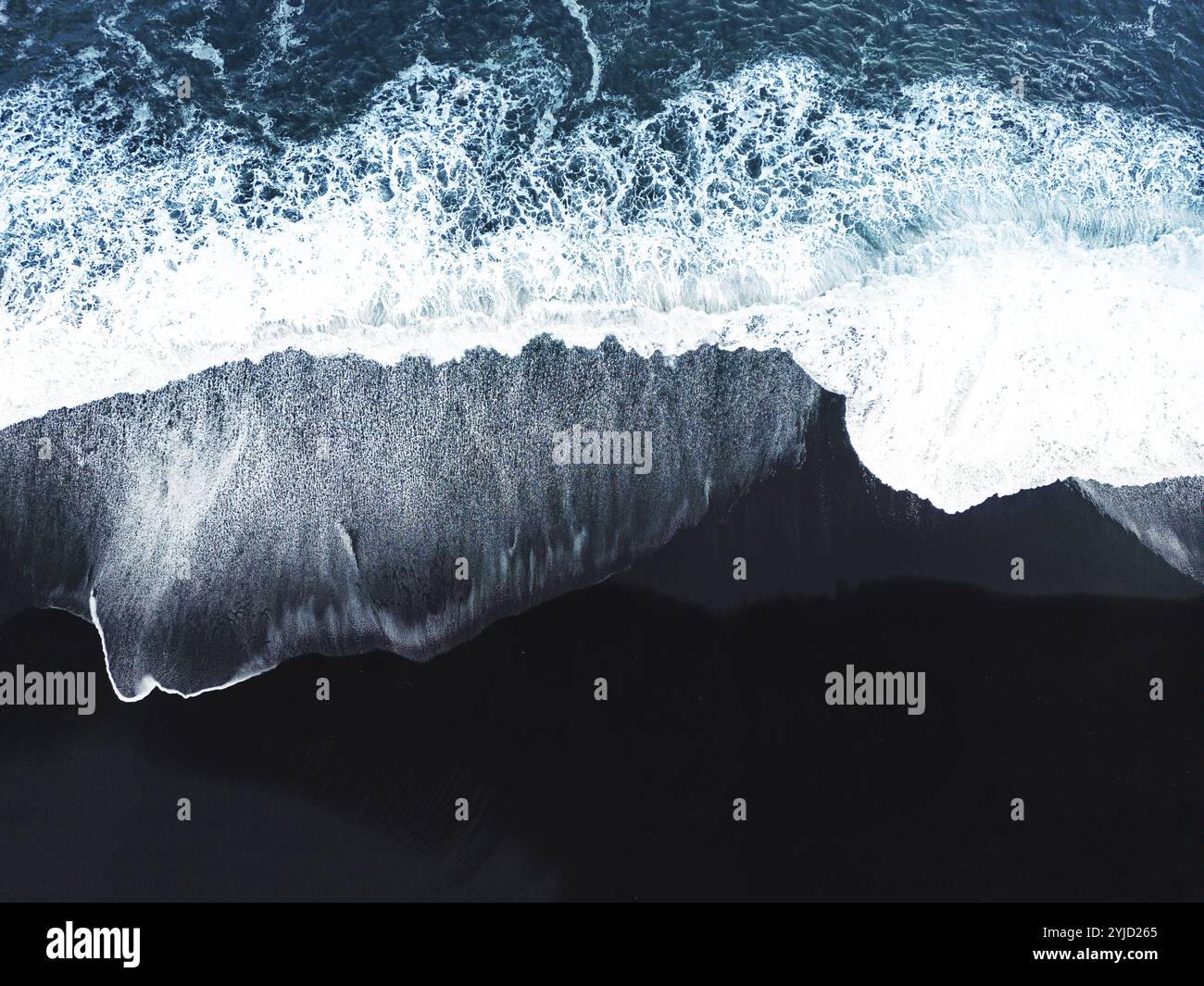 Top down view of waves crashing on the black sands beaches of Selheimasandur in Southern Iceland. Stock Photo