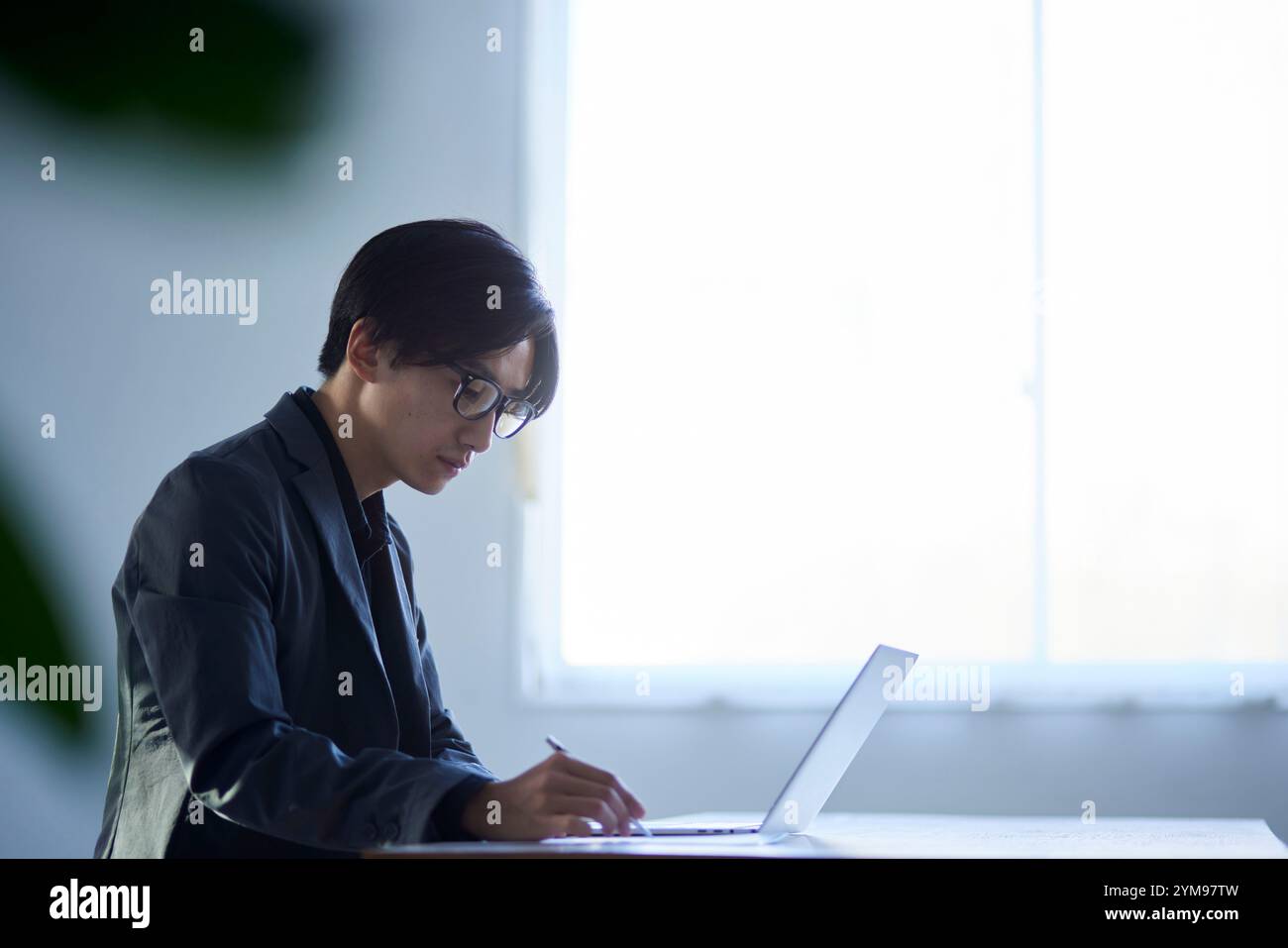 Japanese male architect designing in an architectural office Stock Photo