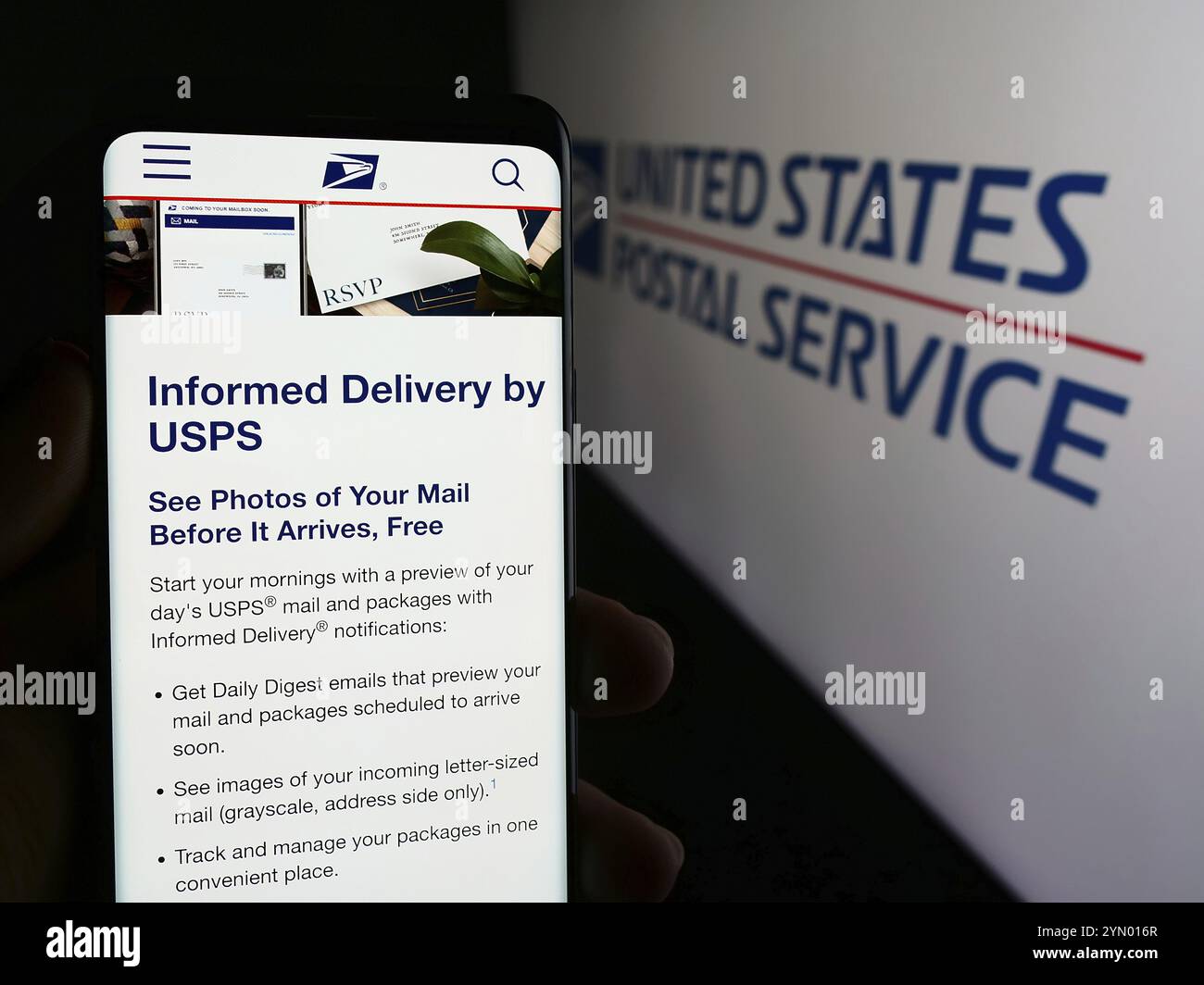 Stuttgart, Germany, 06-14-2024: Person holding cellphone with web page of US agency United States Postal Service (USPS) in front of logo. Focus on cen Stock Photo