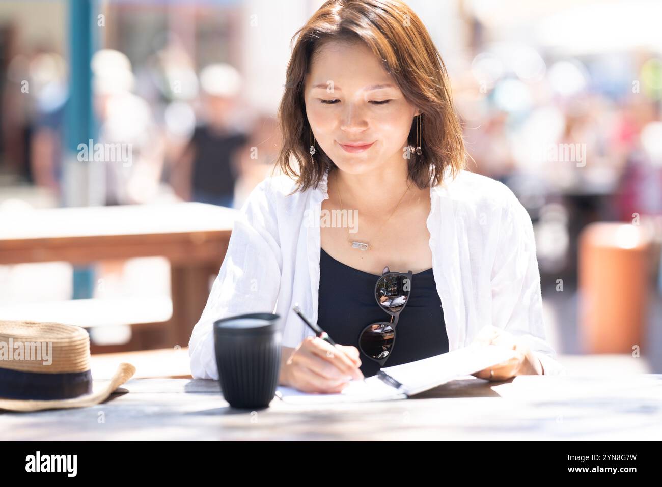 Woman in the city with notebook open and writing something Stock Photo