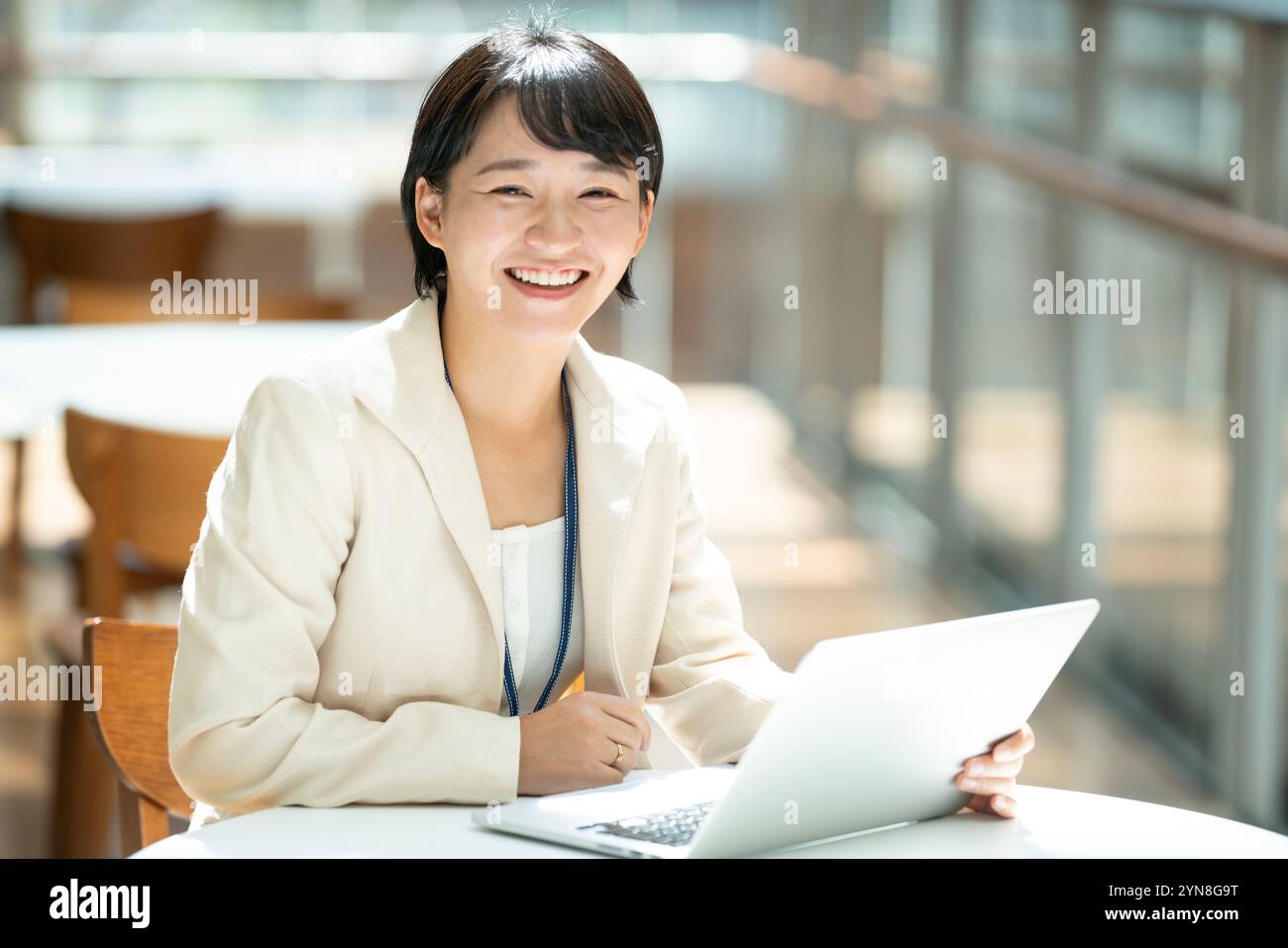 Woman in suit working with computer spread out Stock Photo