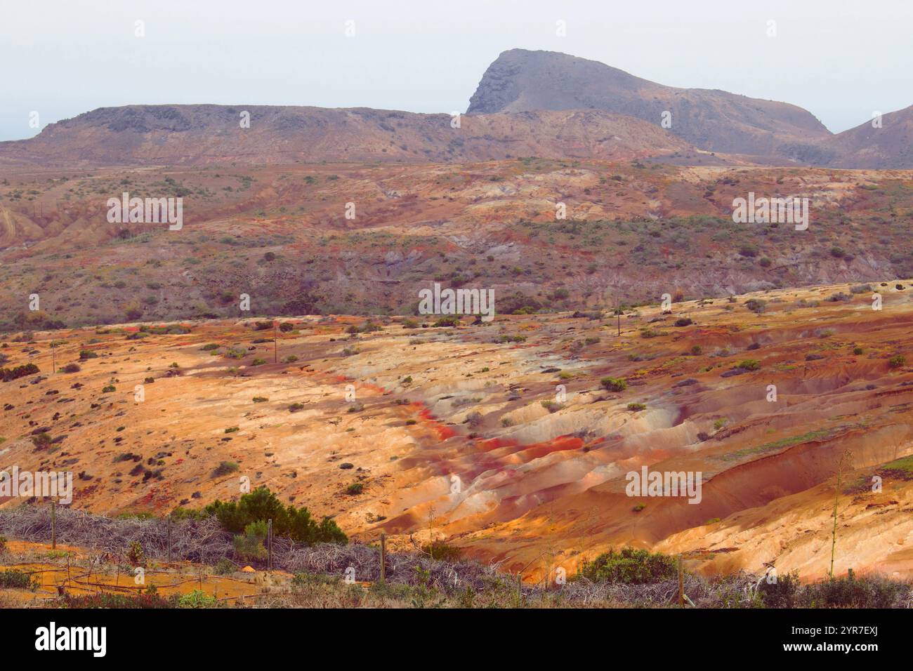 A kaleidoscope of colors and textures unfolds across Saint Helena’s volcanic rock formations, a natural masterpiece sculpted by time and the Atlantic’ Stock Photo