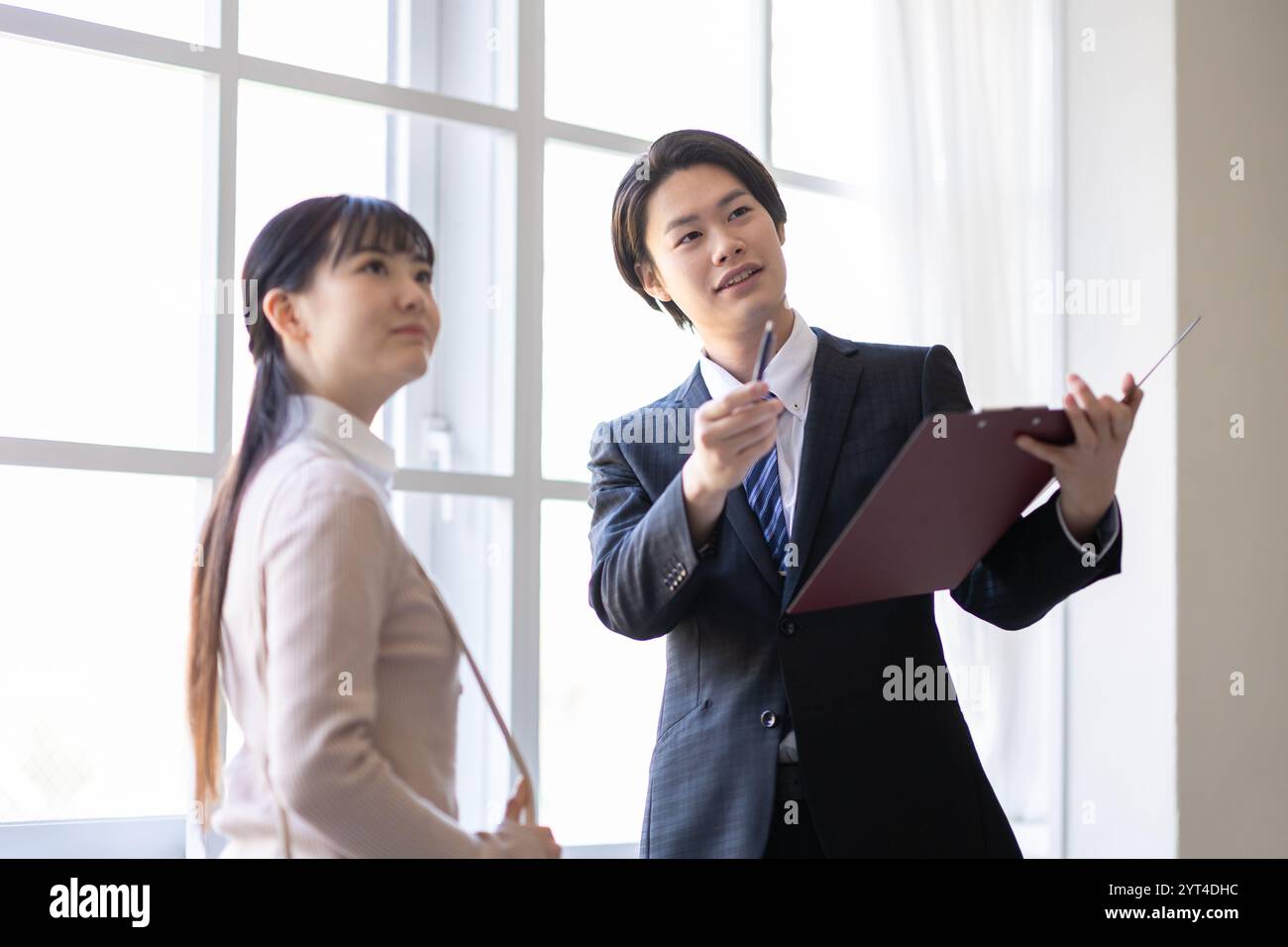 Woman and real estate agency man viewing a property Stock Photo