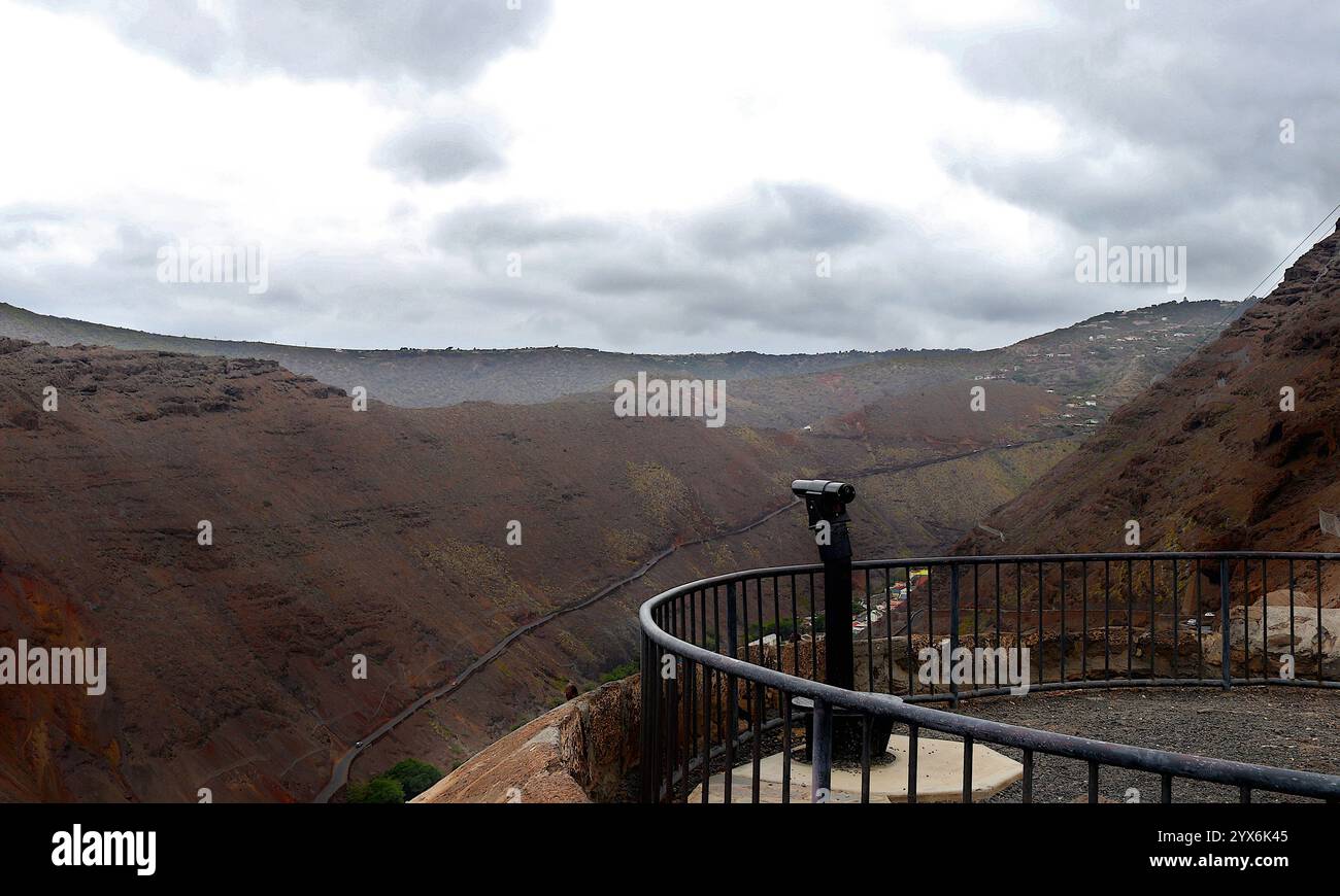 Scenic overlook atop Jacob's Ladder, Saint Helena, featuring rugged terrain and a telescope framing the island's natural beauty. Stock Photo