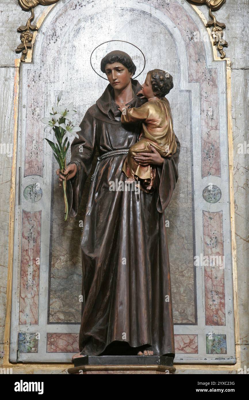 Saint Anthony with the baby Jesus, statue on the altar of Saint Anthony of Padua in the Franciscan Church of the Holy Trinity in Slavonski Brod, Croat Stock Photo