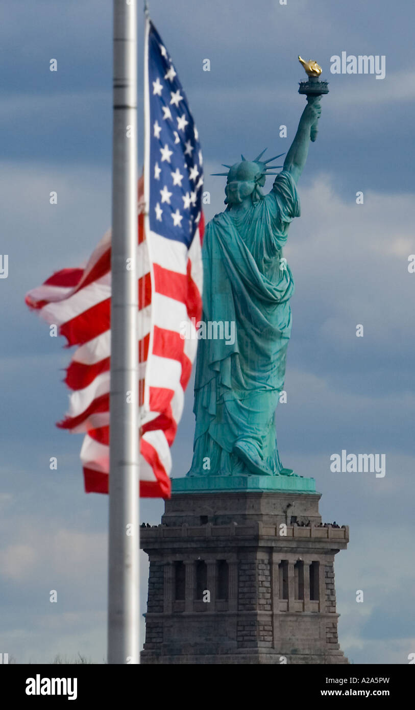 United States flag with the Statue of Liberty in the background Stock Photo