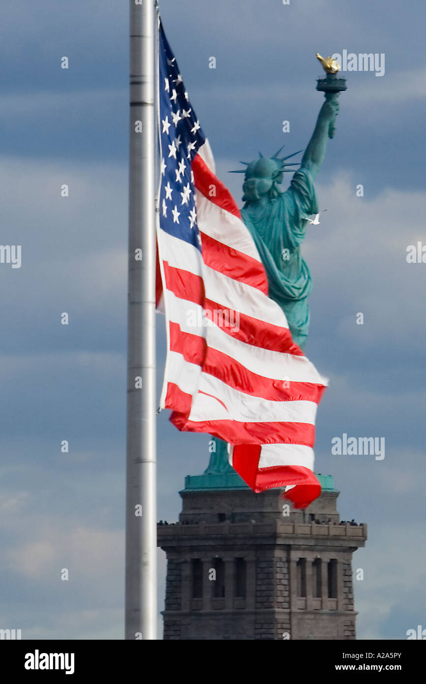 United States flag with the Statue of Liberty in the background Stock Photo