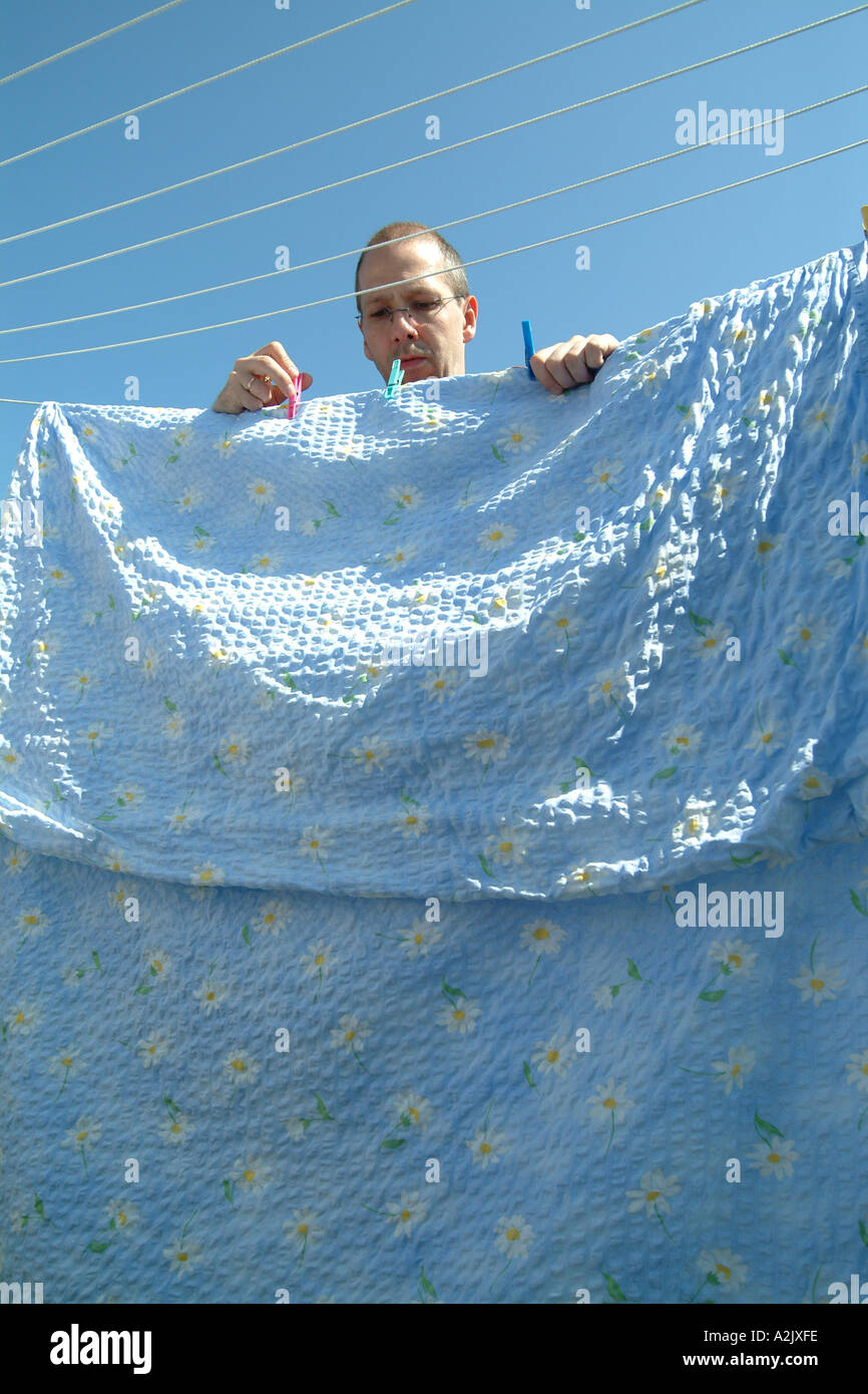 man hanging out the washing Stock Photo