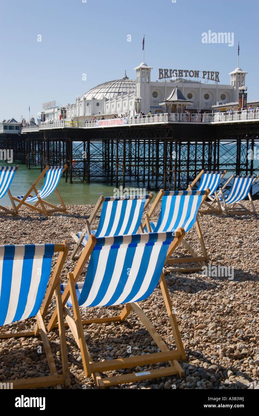 ENGLAND East Sussex Brighton Pier and Beach with empty deck chairs on pebble shingle beach Stock Photo