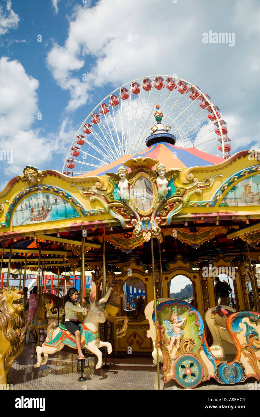 CHICAGO Illinois Girl ride Merry go round at Navy Pier ferris wheel amusement rides Stock Photo