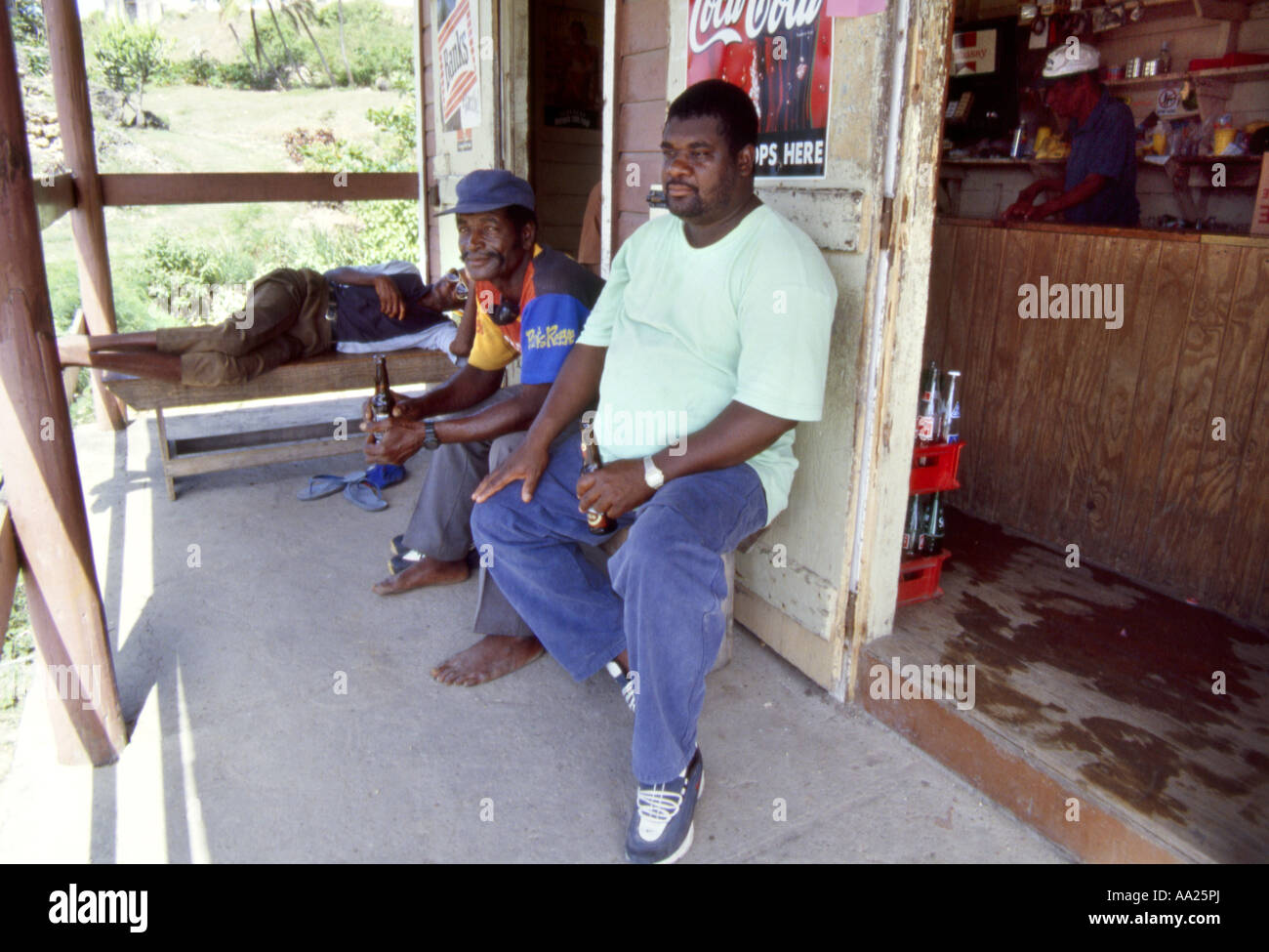 Men relax at a drink shack in Bathsheba on the East coast of  Barbados Stock Photo