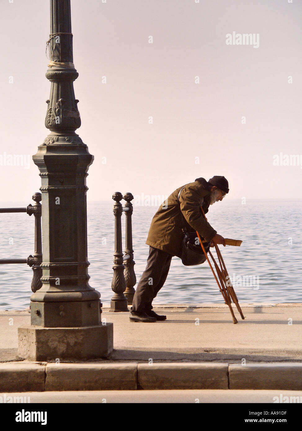 poor man on crutches begging for money Thessaloniki Greece Stock Photo