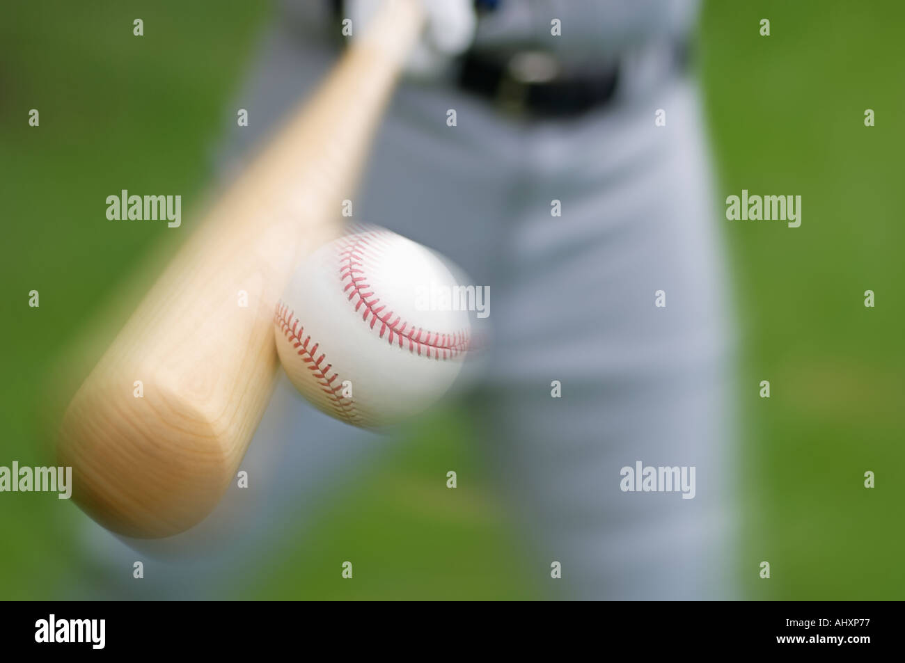 Closeup of baseball player hitting ball Stock Photo