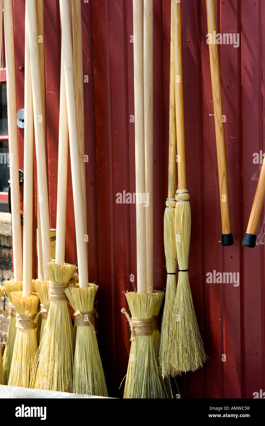 Brooms on display for sale at broom factory Stock Photo