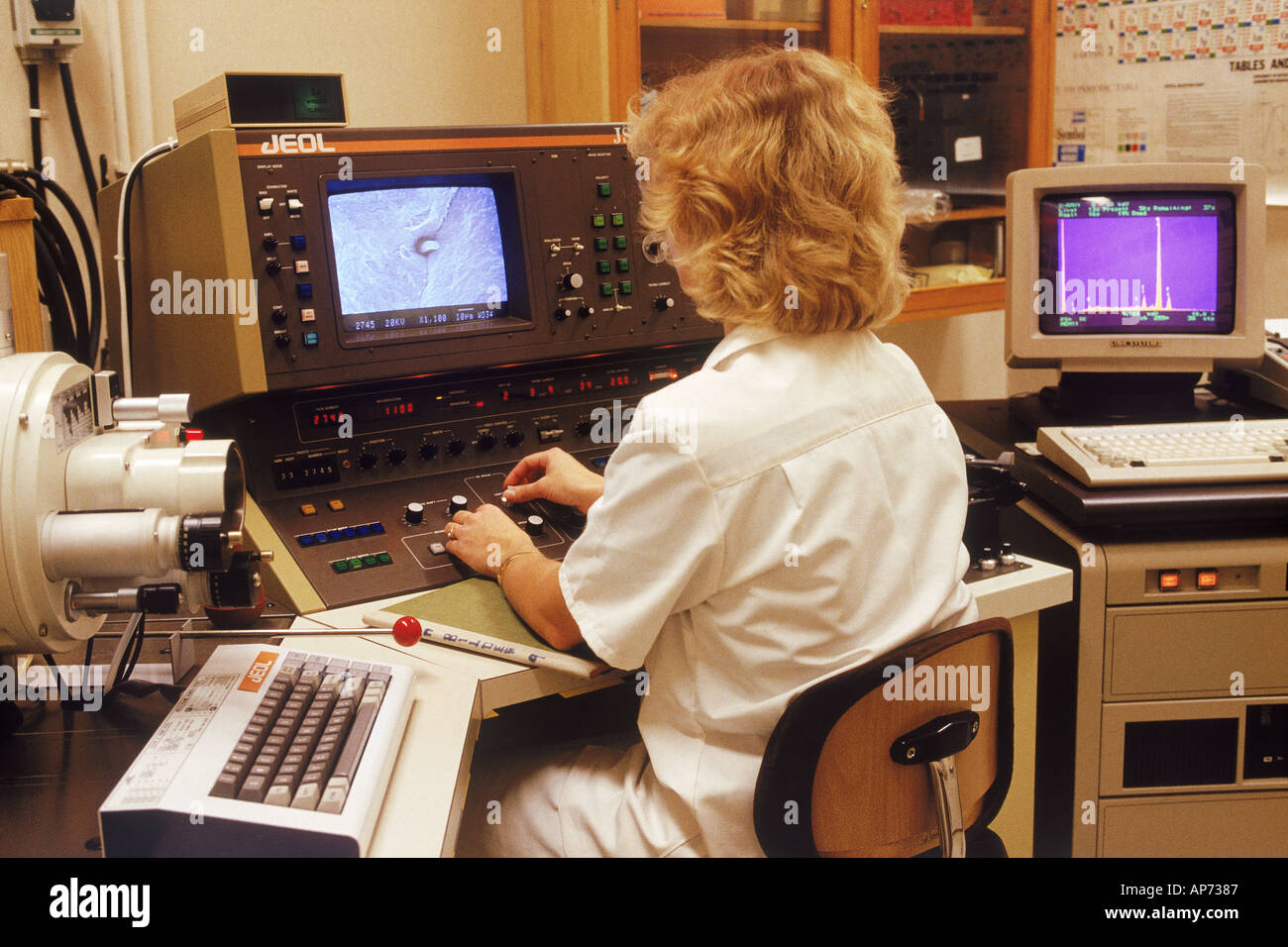 Woman in research lab with scanning electron microscope and x ray analyzer Stock Photo