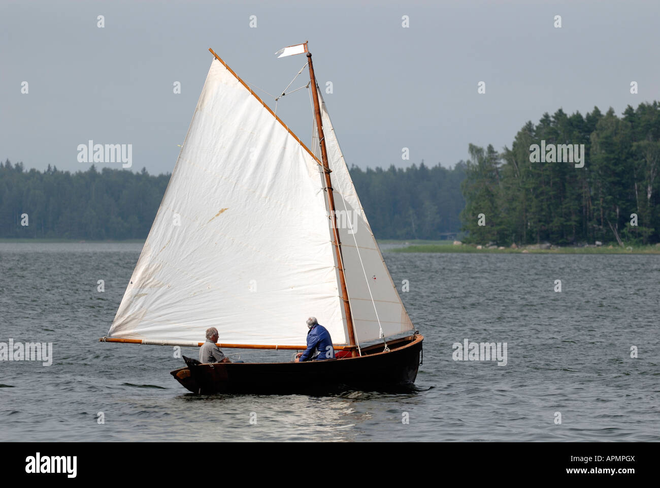 An old couple and a wooden sailing boat in the Porvoo Archipelago, Porvoo, Finland, Europe. Stock Photo