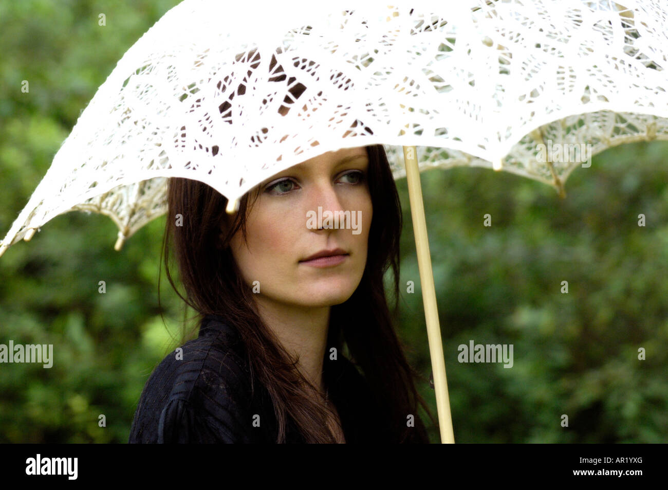 Young attractive woman with parasol Stock Photo