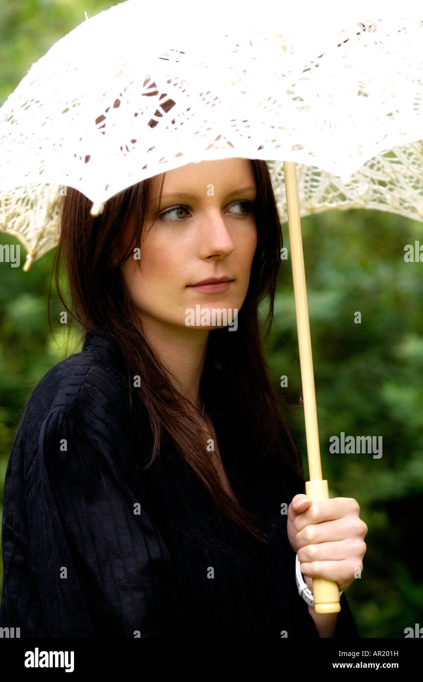 Young attractive woman with parasol Stock Photo