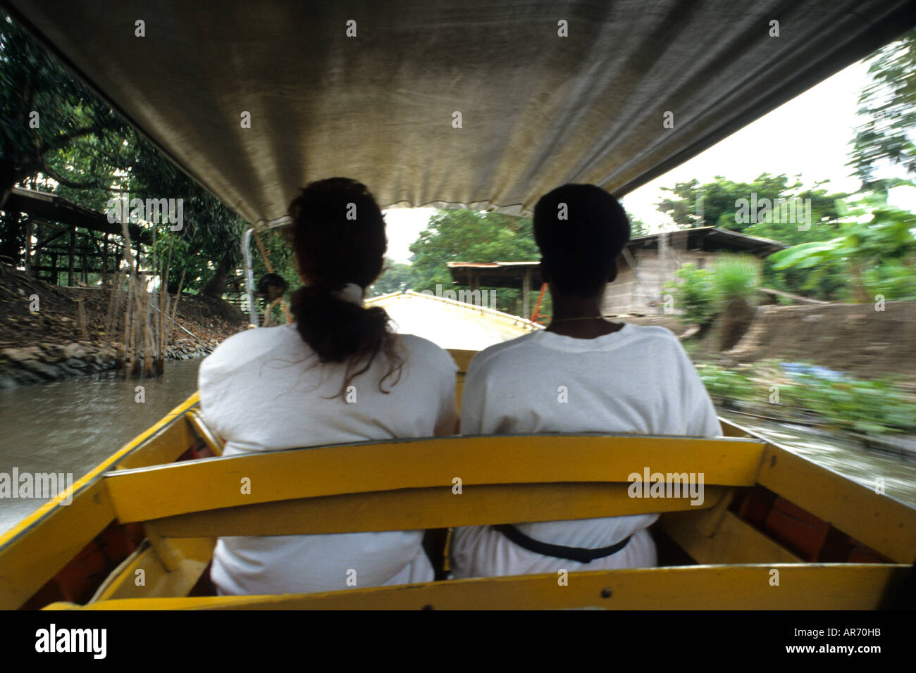 Riding old fashioned boat in canals in country outside of Bangkok Thailand Stock Photo