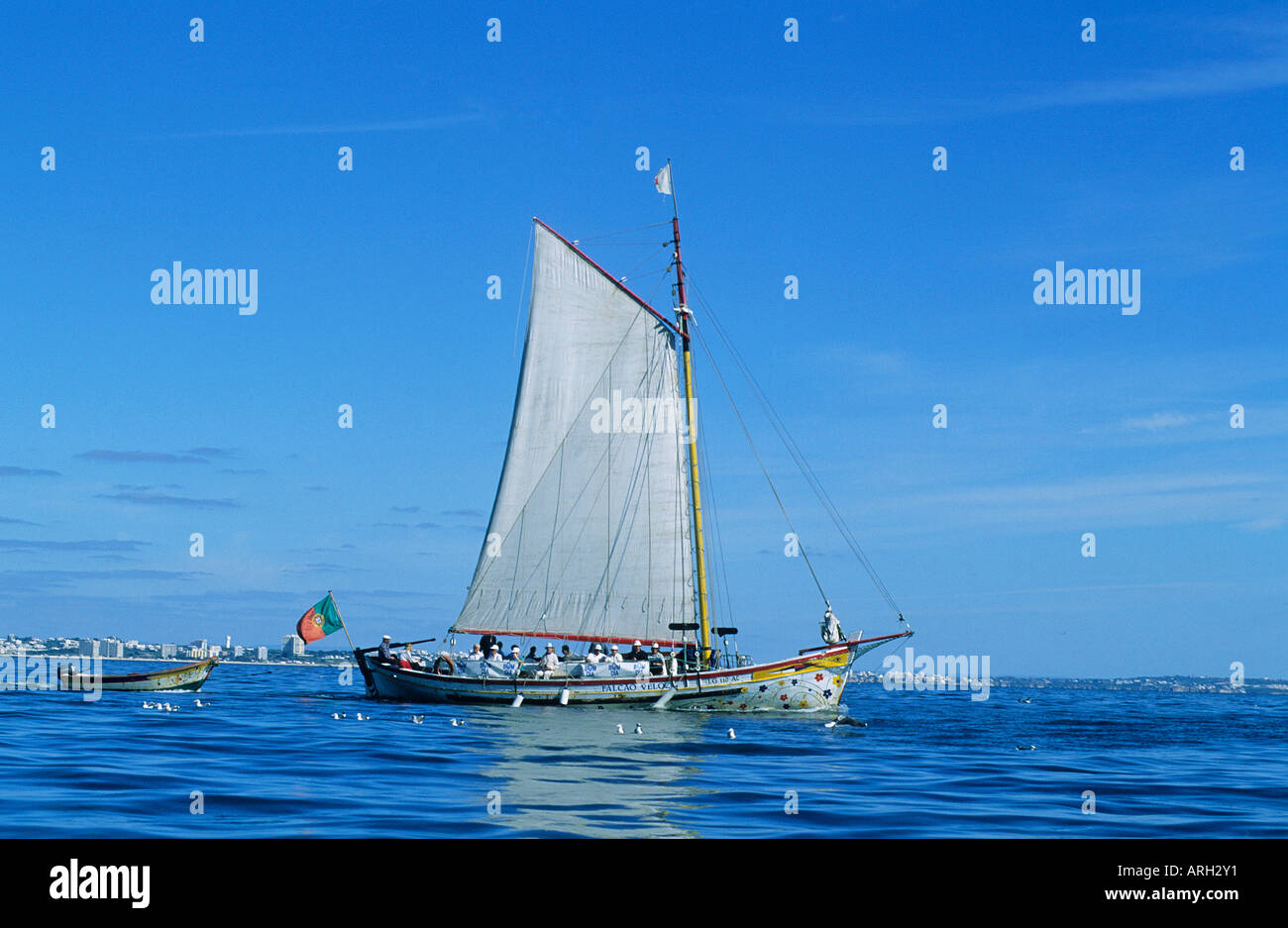 Sail set an old fashioned boat taking tourists on a sailing trip from the port of Portimao set on the western bank of the River Arade Stock Photo