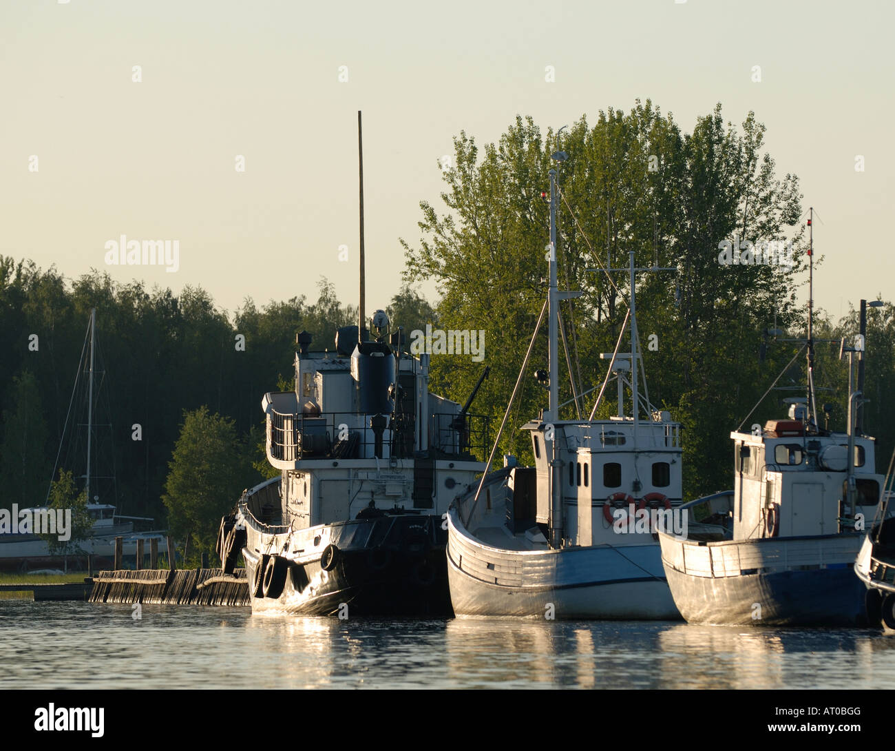 The fishing boats berthed along the Porvoo river at sunset, Porvoo, Finland, Europe. Stock Photo