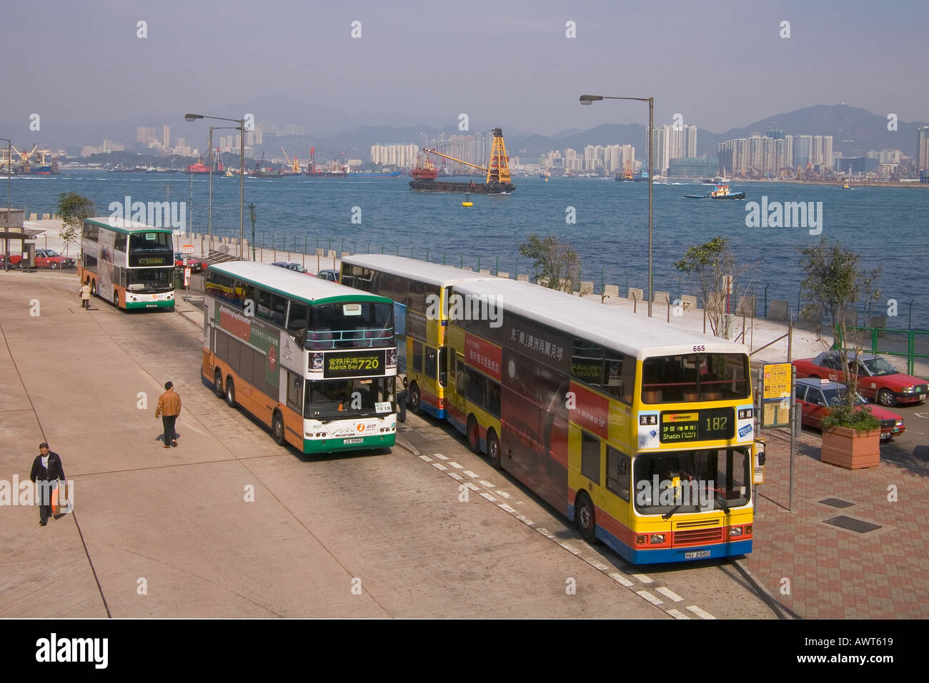 dh Bus Terminal SHEUNG WAN HONG KONG Macau Ferry Pier Citybus and First bus parked waiting stance transport double deck buses Stock Photo