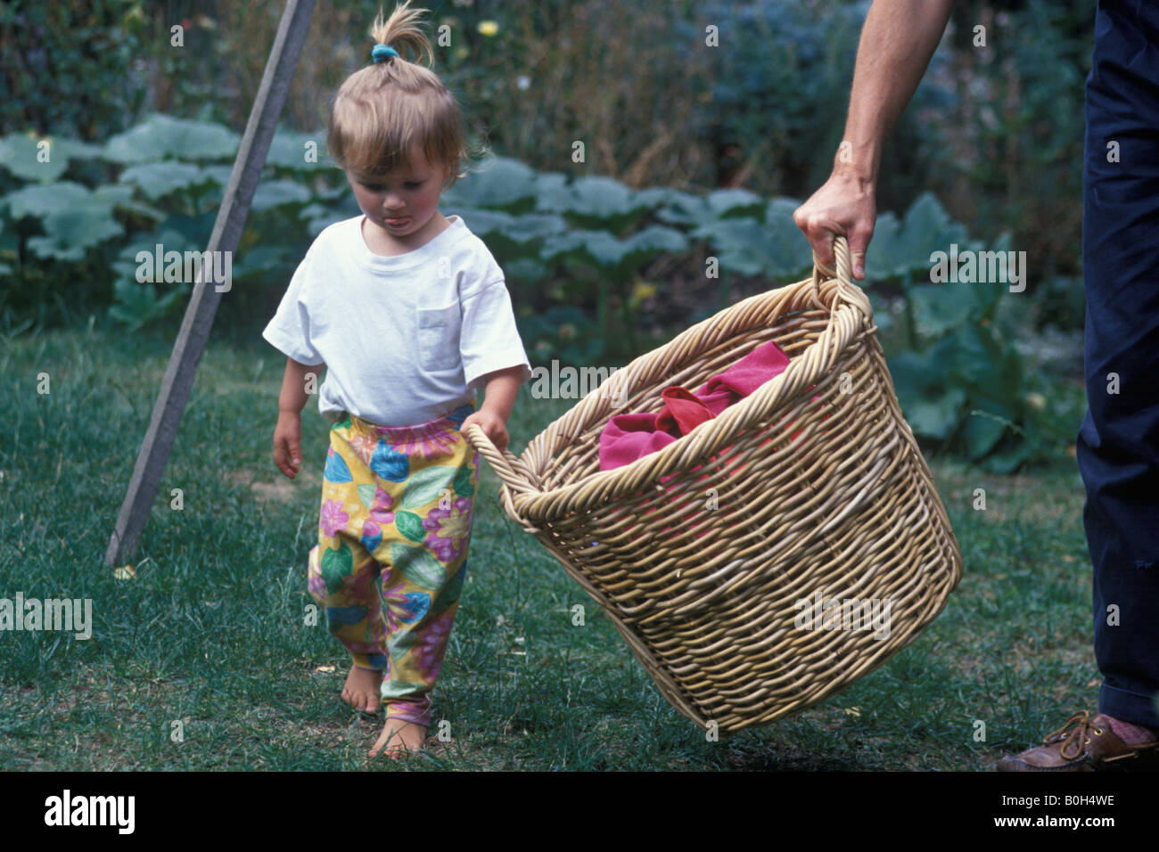 child helping to hang out washing Stock Photo