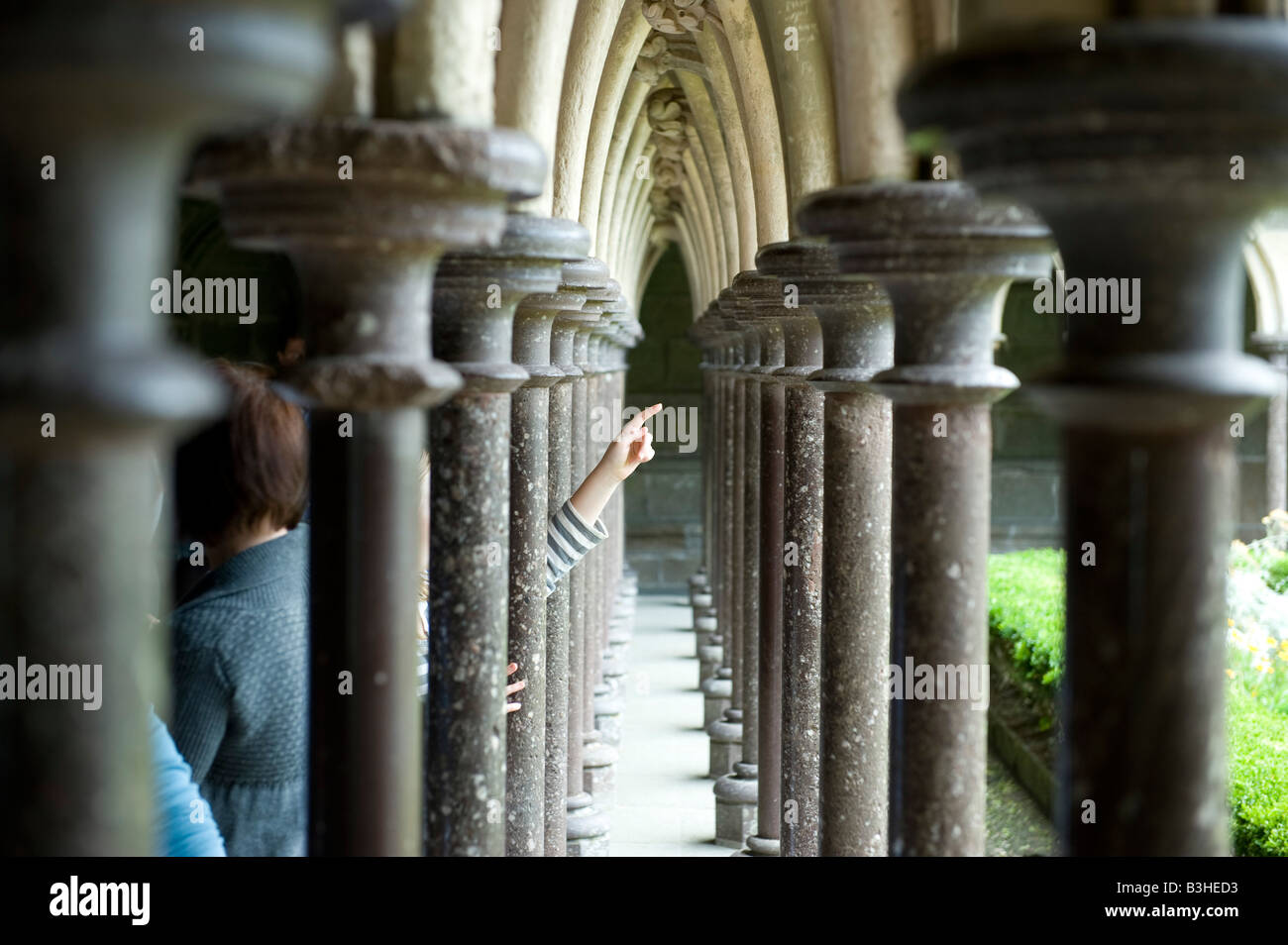 Details are highlighted by a guide to Normandy,Mont St Michel in France  in the Benedictine cloister Stock Photo