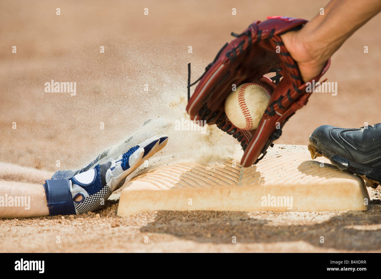 Baseball player sliding into home base Stock Photo