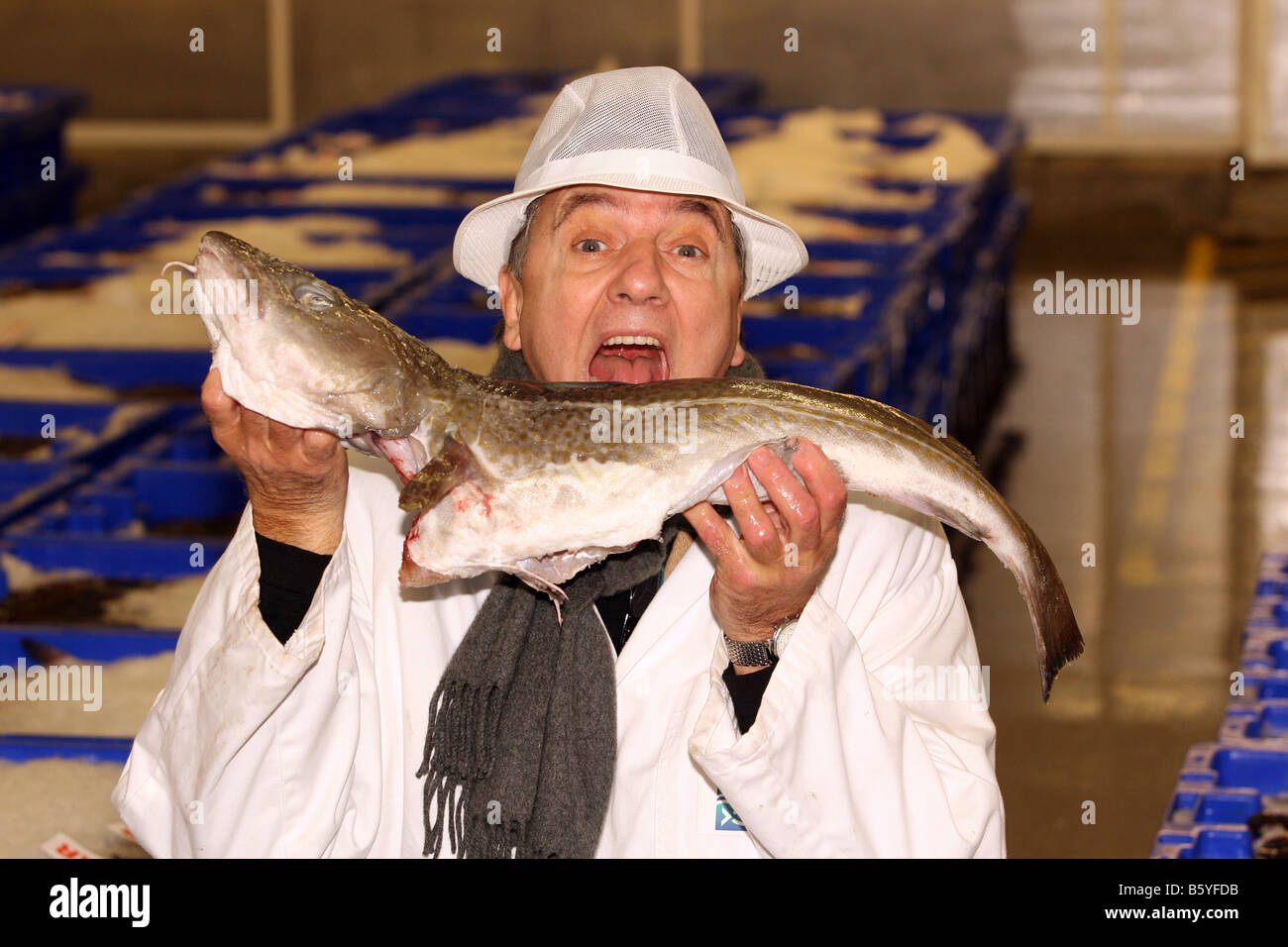 Famous French chef Raymond Blanc holding a cod at Peterhead fish market in Aberdeenshire, Scotland, UK Stock Photo