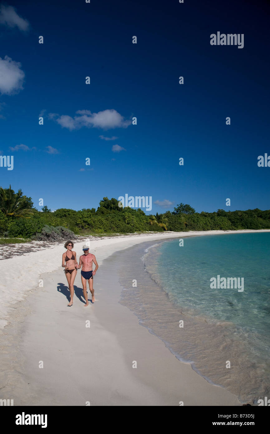 Older couple running on beach in Vieques Puerto Rico Stock Photo